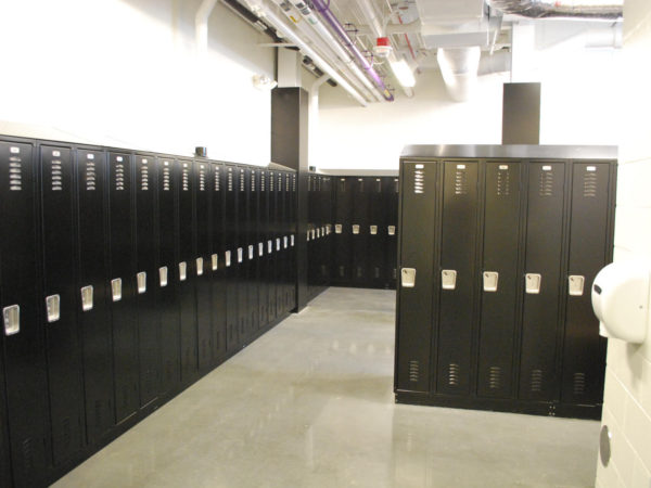 Single-tier metal lockers in a locker room, with a black finish.