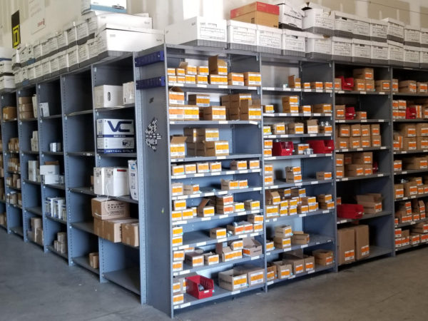 Gray metal shelving with products on the shelves.