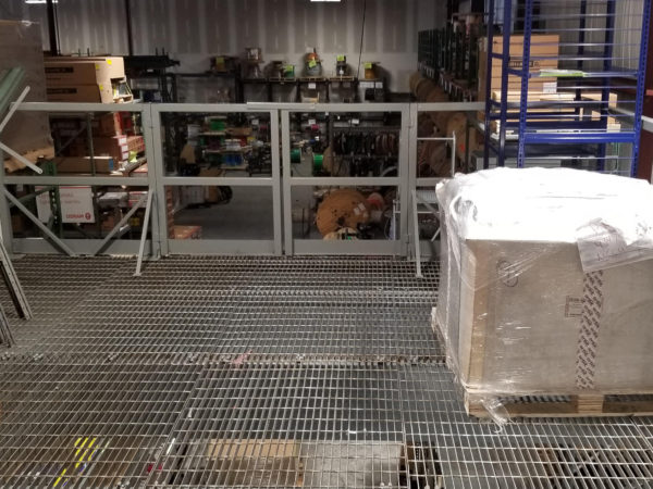 Standing on a mezzanine looking down into a warehouse filled with product.