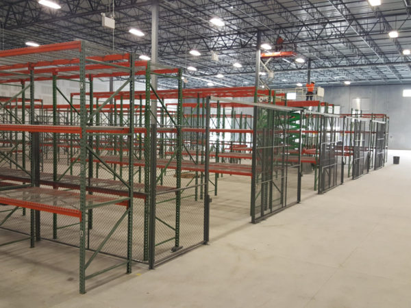 Pallet rack inside and outside a wire partition cage.