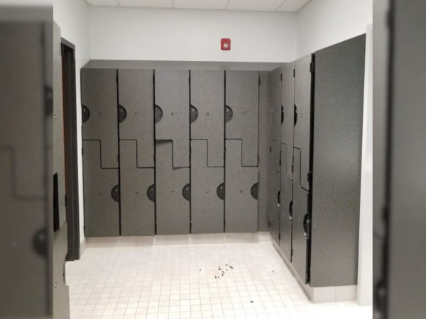 Plastic laminate z-lockers in a locker room, with a gray finish.