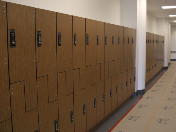 Phenolic z-lockers in a hallway with a pecan woodline finish, by PSiSC.