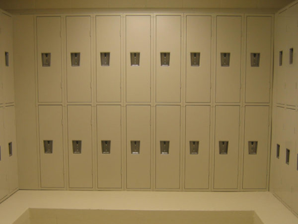 Two-tier quiet metal lockers in a locker room, with a tan finish.