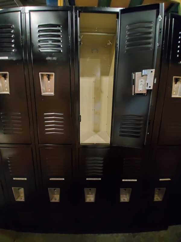 Used two-tier metal lockers with a black outer finish and tan inner finish.