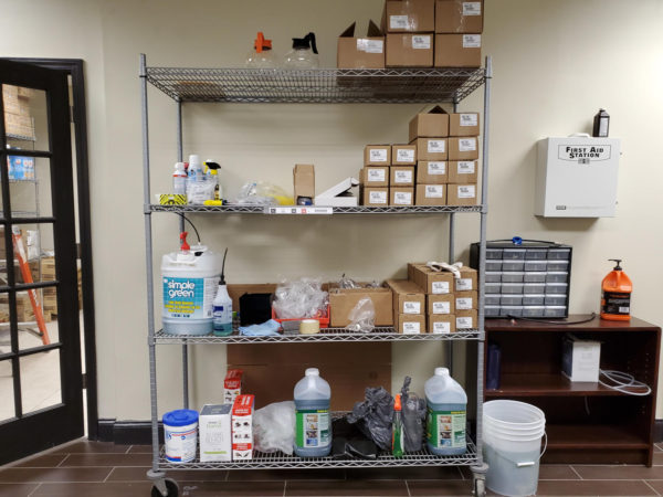 Wire shelving filled with cleaning supplies.