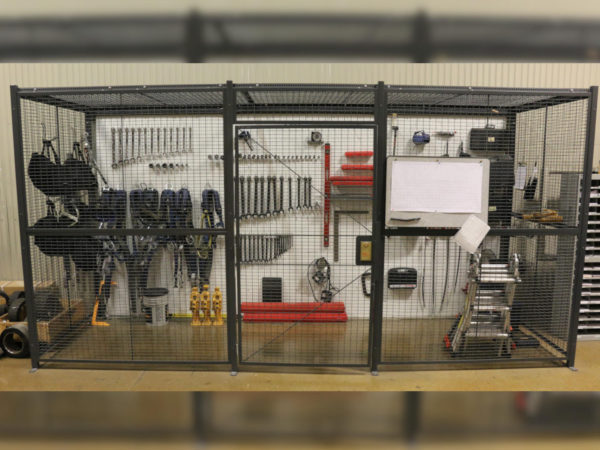 Wire partition cage functioning as a tool cage filled with equipment, by Wirecrafters.