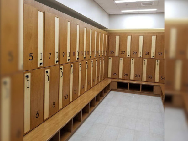 Two-tier wood lockers in a locker room.