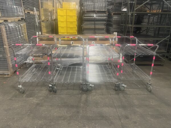 Four wire carts lined up next to each other.