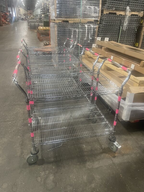 Four wire carts lined up next to each other.