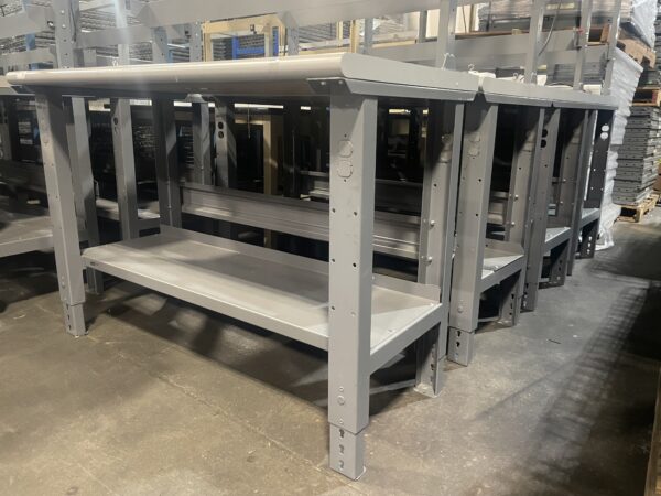 Legs of used 24x48 workbenches with back risers and light bars