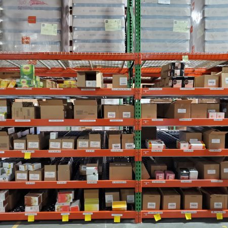 Carton flow rack filled with boxes in a warehouse.