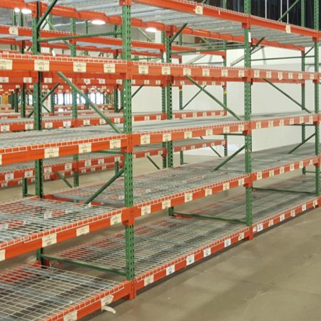 Pallet rack with wire deck in a warehouse.