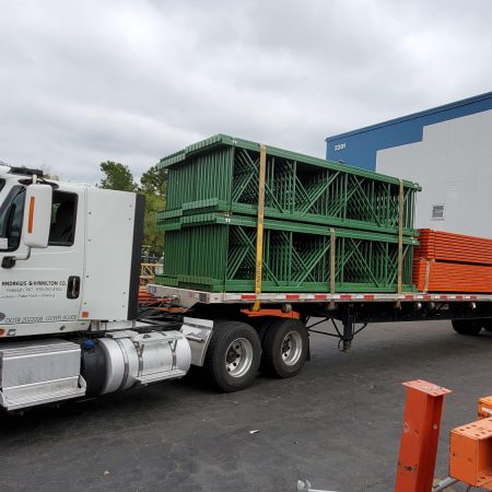 Andrews and Hamilton truck with pallet rack, wire decking, and post protectors.